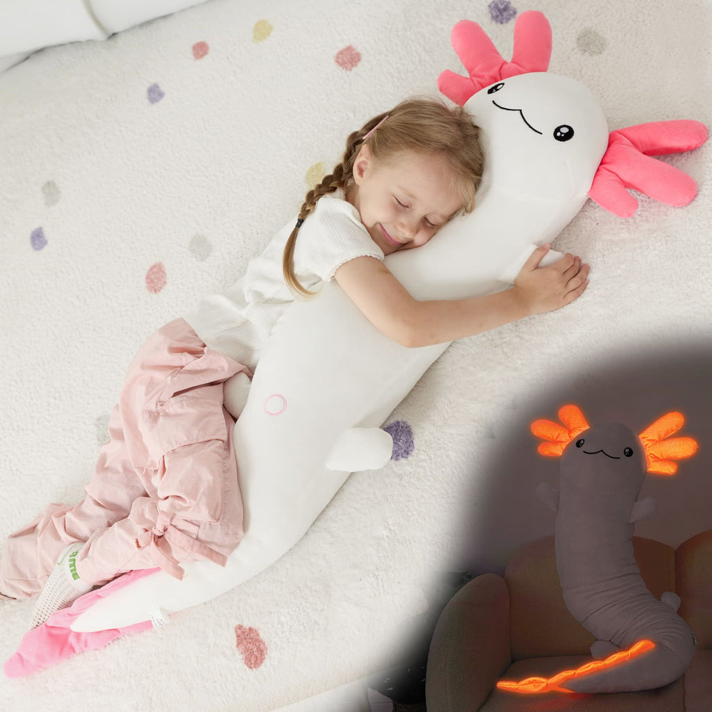 Child sleeping with a large plush toy resembling a cartoon character on a soft surface.